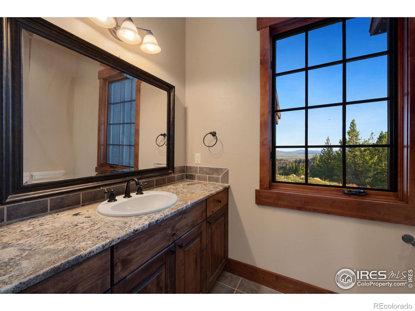 More natural light from additional bathroom fostering views of the peaks to the south