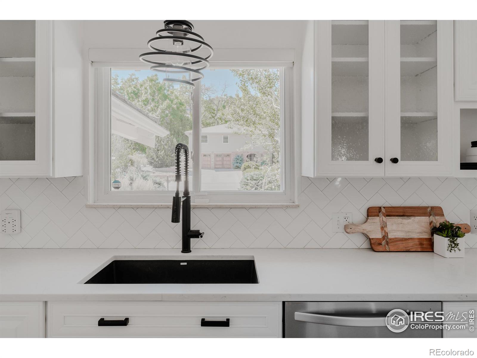 A window above the kitchen sink lets natural light flood in, creating a cheerful atmosphere for daily kitchen tasks.