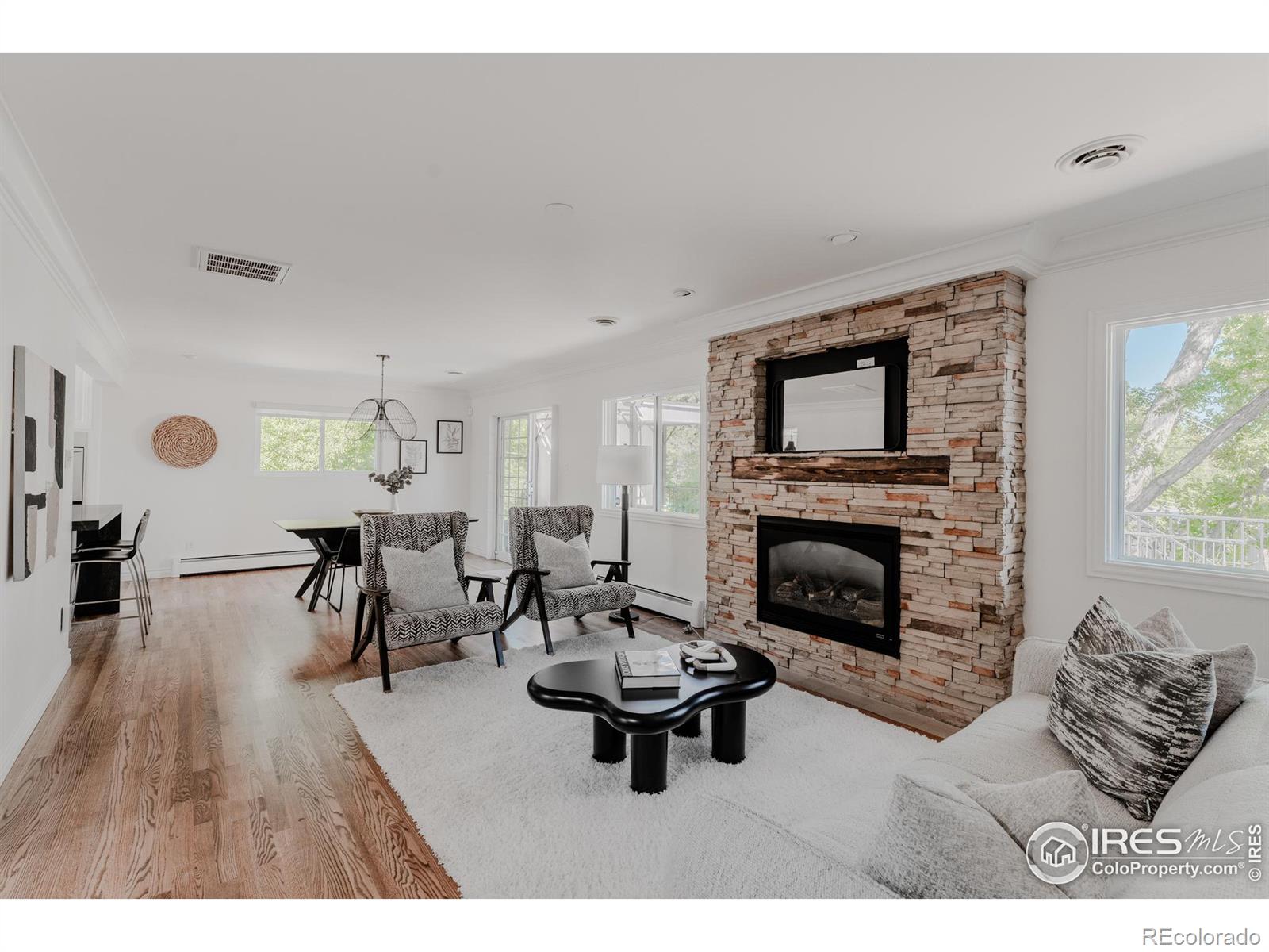 A stacked stone fireplace inlaid with timber commands attention as the focal point of the family room.