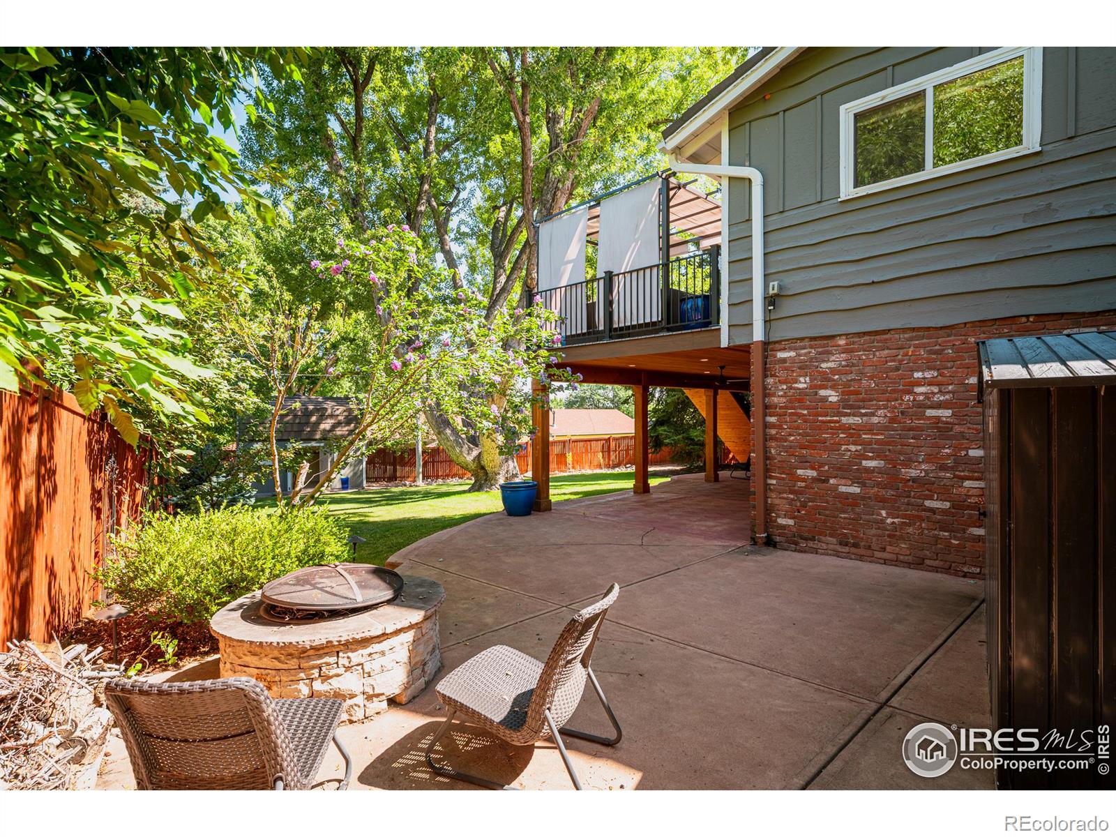 The patio extends the length of the home and wraps around to a cozy fire pit, perfect for roasting smores and enjoying warm, fireside gatherings under the stars.