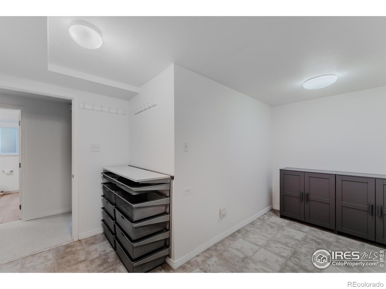 The basement laundry area with included washer and dryer is spacious, featuring built-in drawers and cabinets to ensure everything has its place.