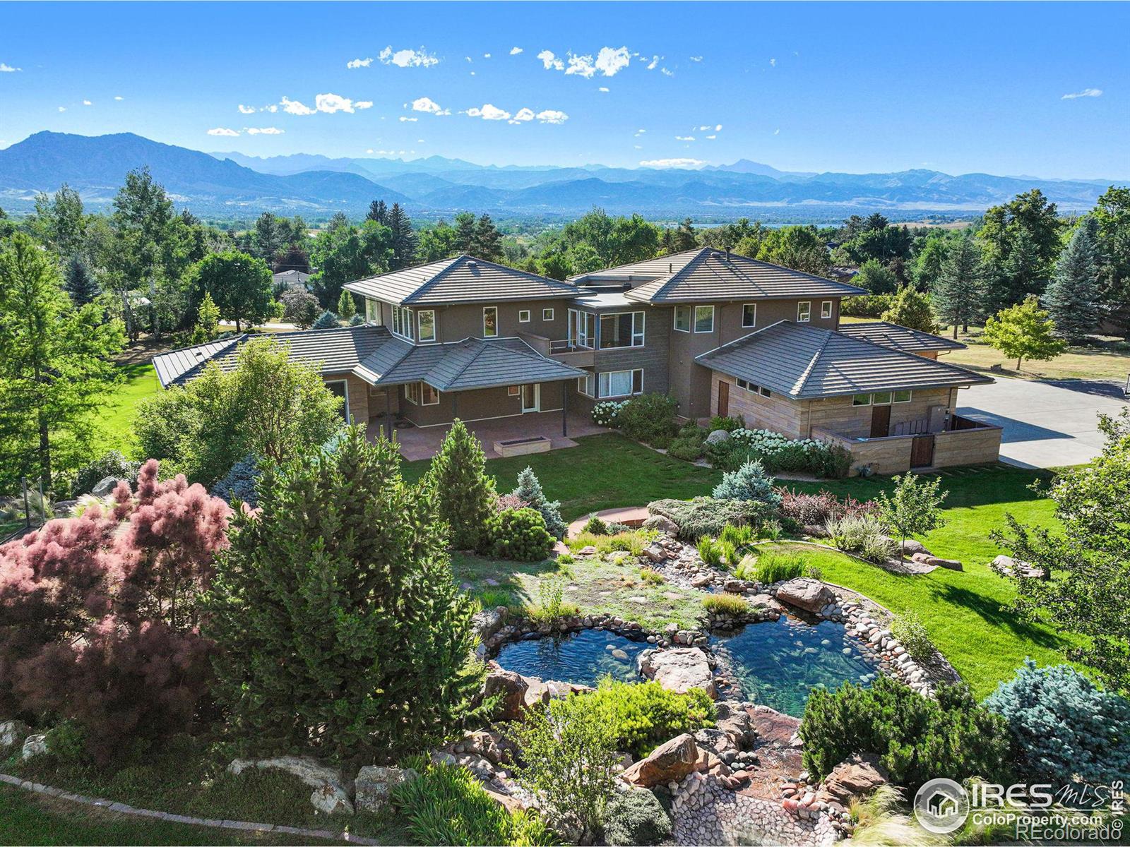 Backyard features mature landscaping, a blend of manicured and natural spaces