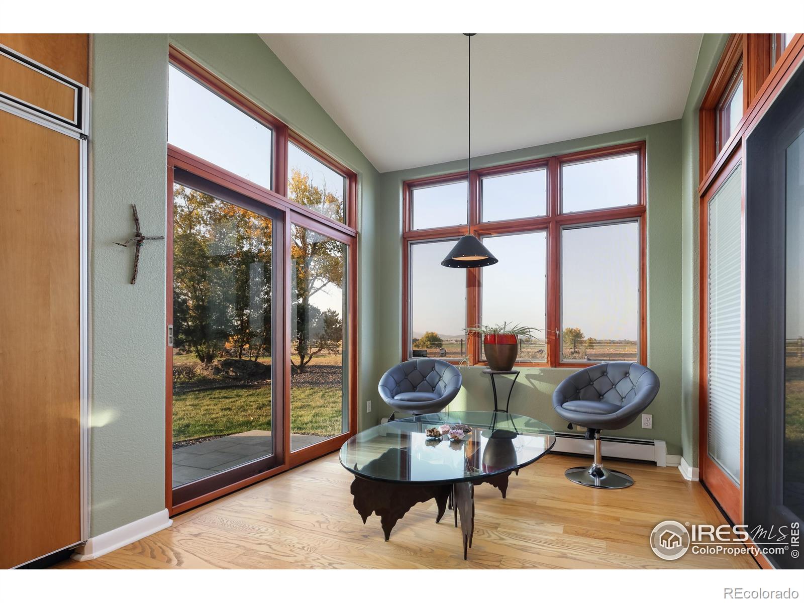 Sun-filled, eat-in kitchen adjacent to the beamed ceiling, formal dining room. The kitchen has an open window countertop to the family room to keep the chef company.