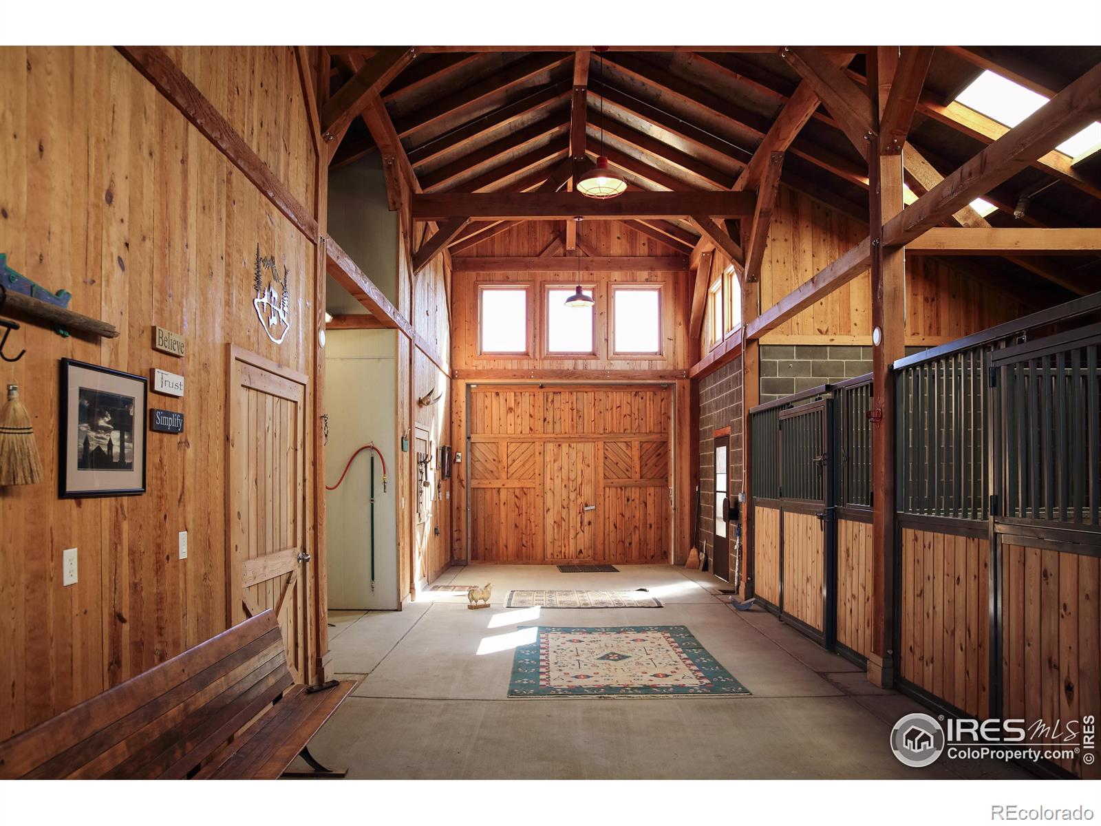 The world class barn includes a heated tack room, wash stall, automated waterers & exterior pens, as well as a great room w/ half bath & an attached greenhouse/sunroom