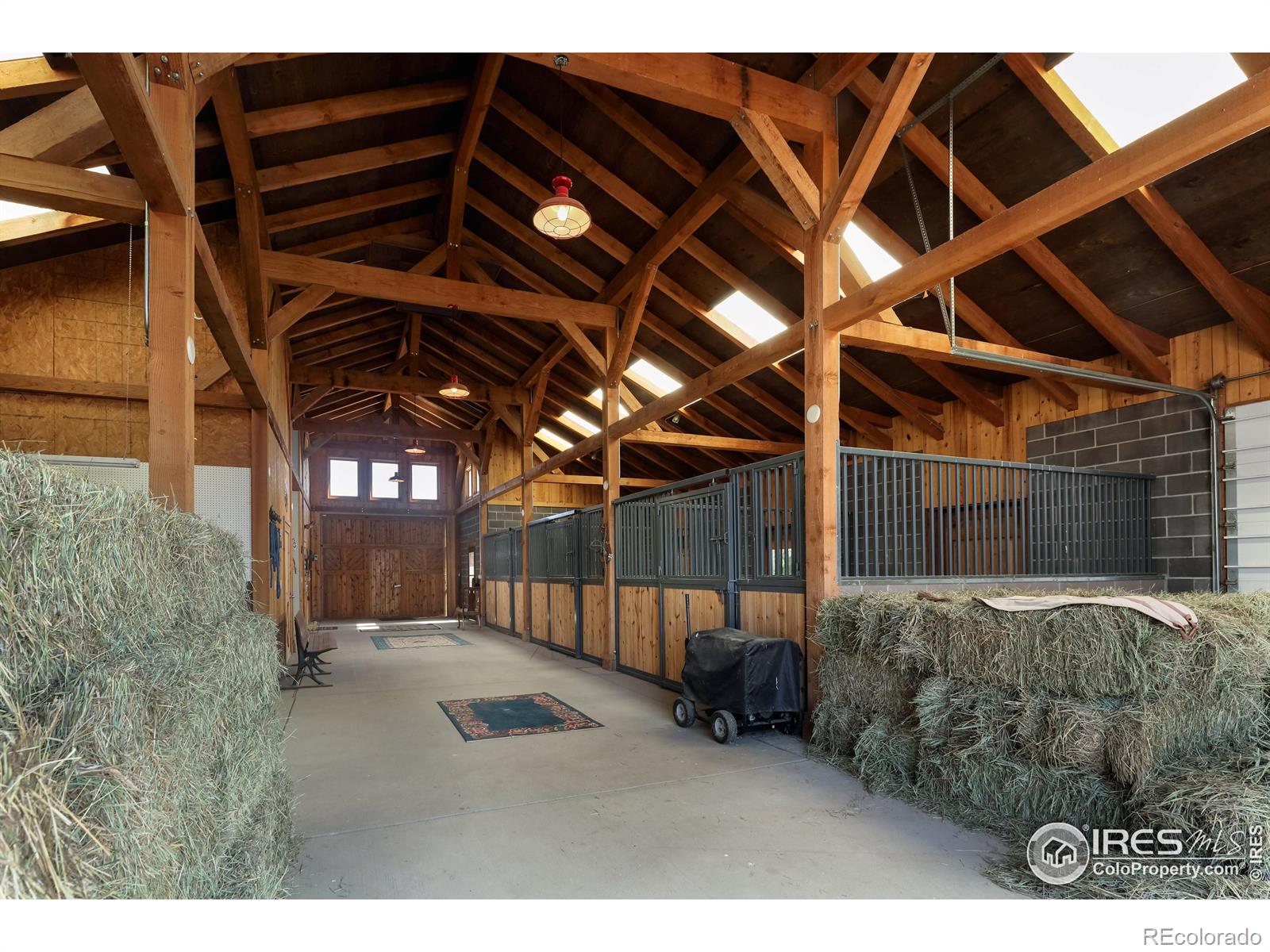 A heated tack room, wash stall, automated waterers & exterior pens, as well as a great room w/ half bath & an attached greenhouse/sunroom