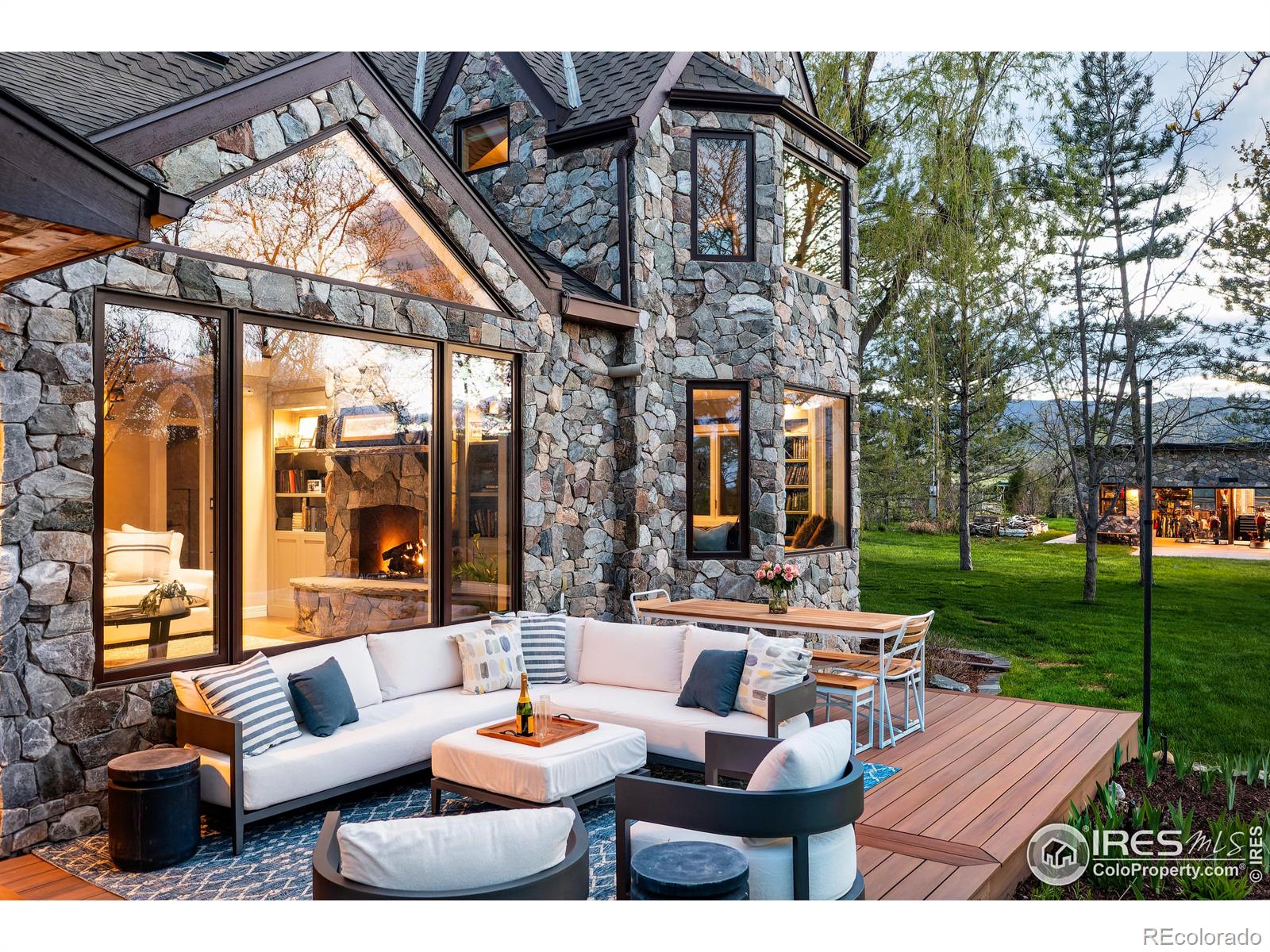 Comfy back yard patio enveloped in luscious greens and blooms and endless open space.