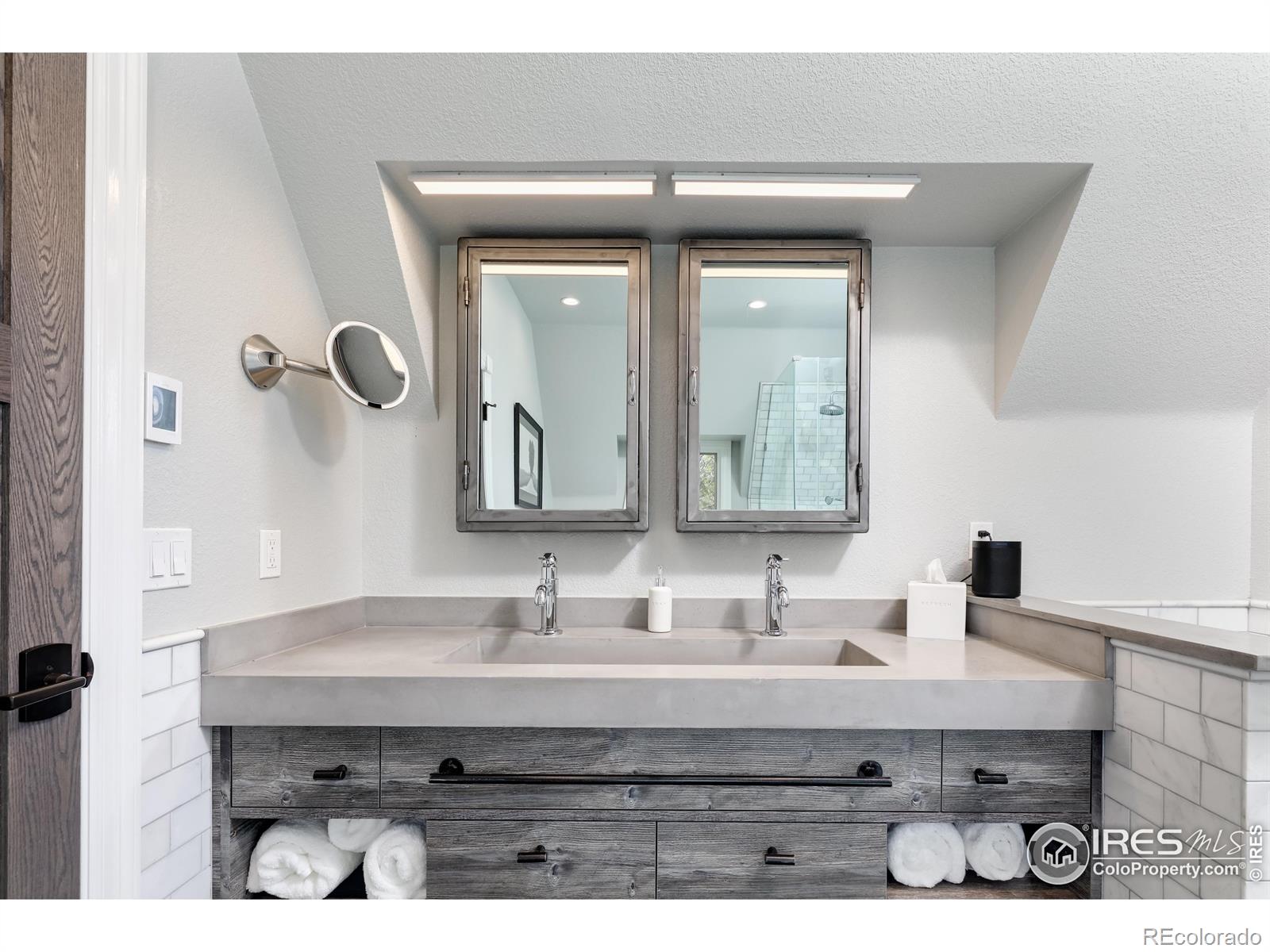 Custom built cement trough sink & marble subway tile throughout primary bathroom paired with MTI Stone tub and shower basin