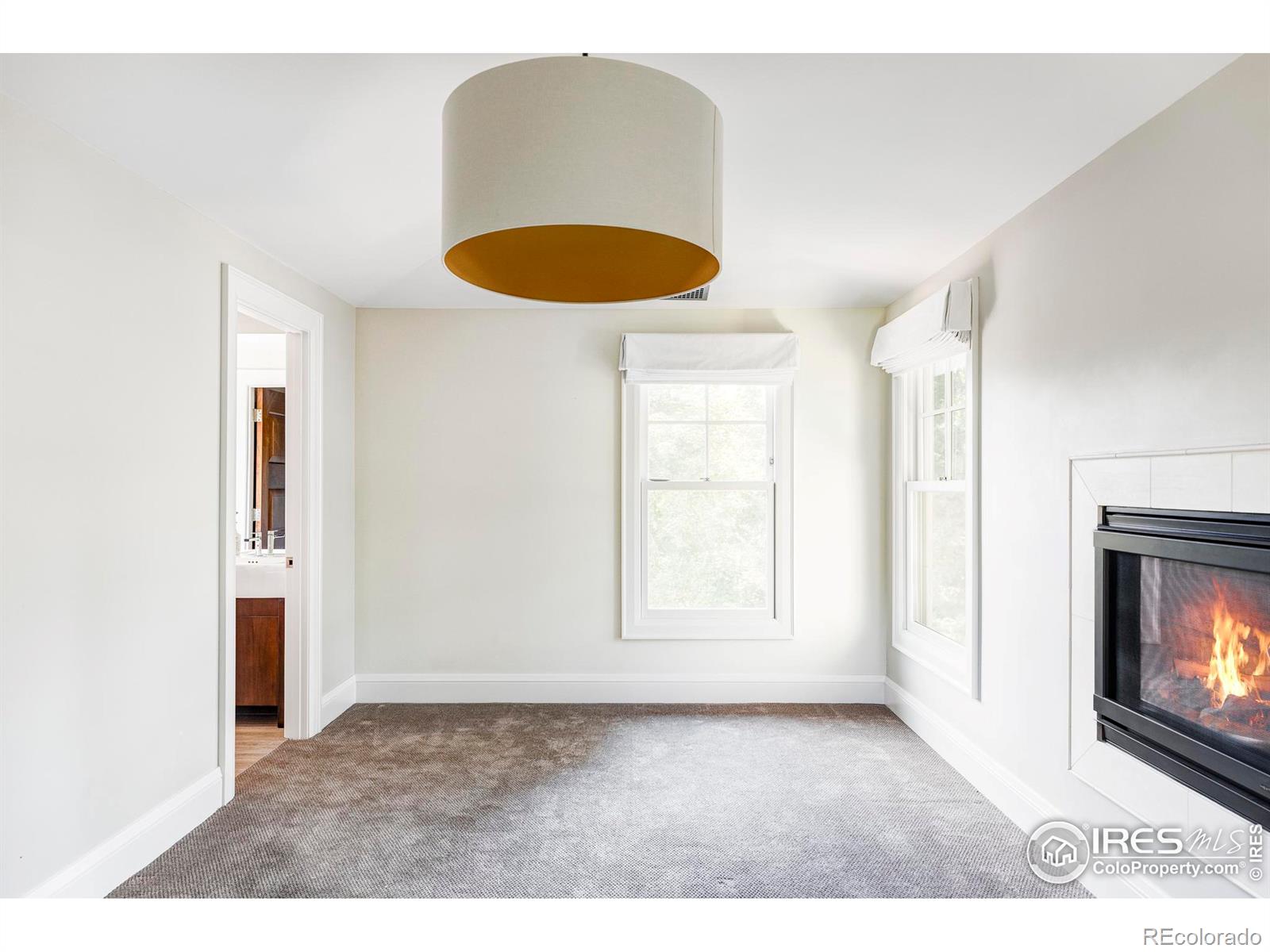 Guest bedroom with a gas fireplace.