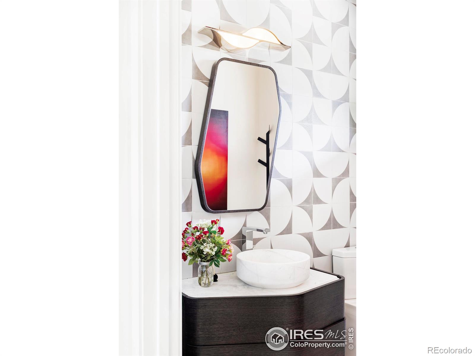 Powder room with Porcelanosa vanity and sink.