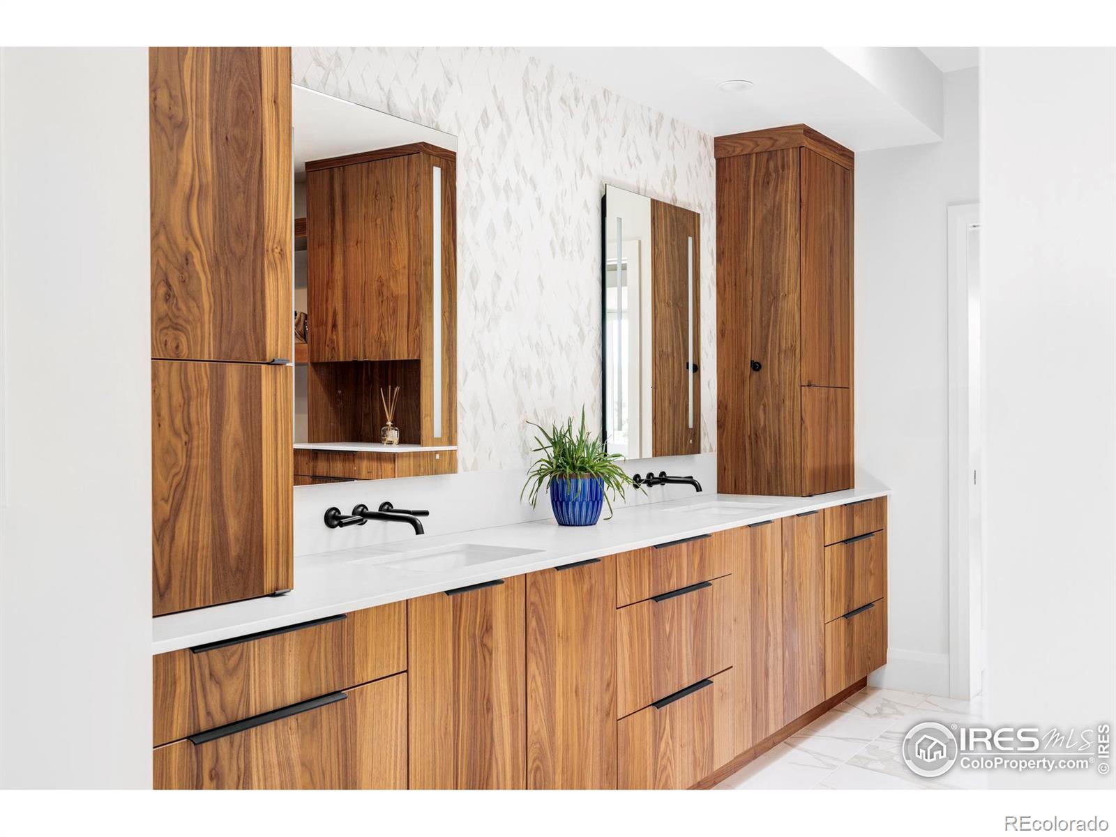 The oversized en suite bathroom includes walnut cabinets and a double vanity with generous walnut storage.