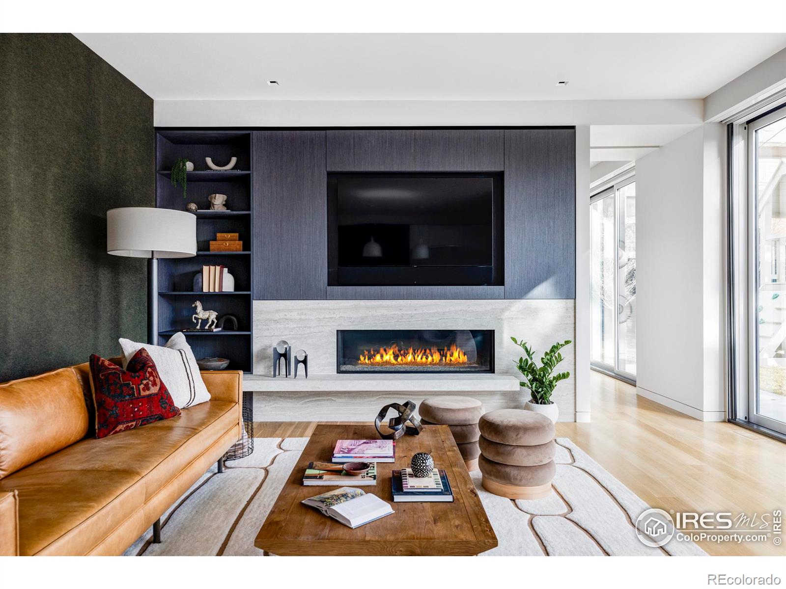 The sprawling living room features a 60-inch linear fireplace and dramatic Neolith surround.