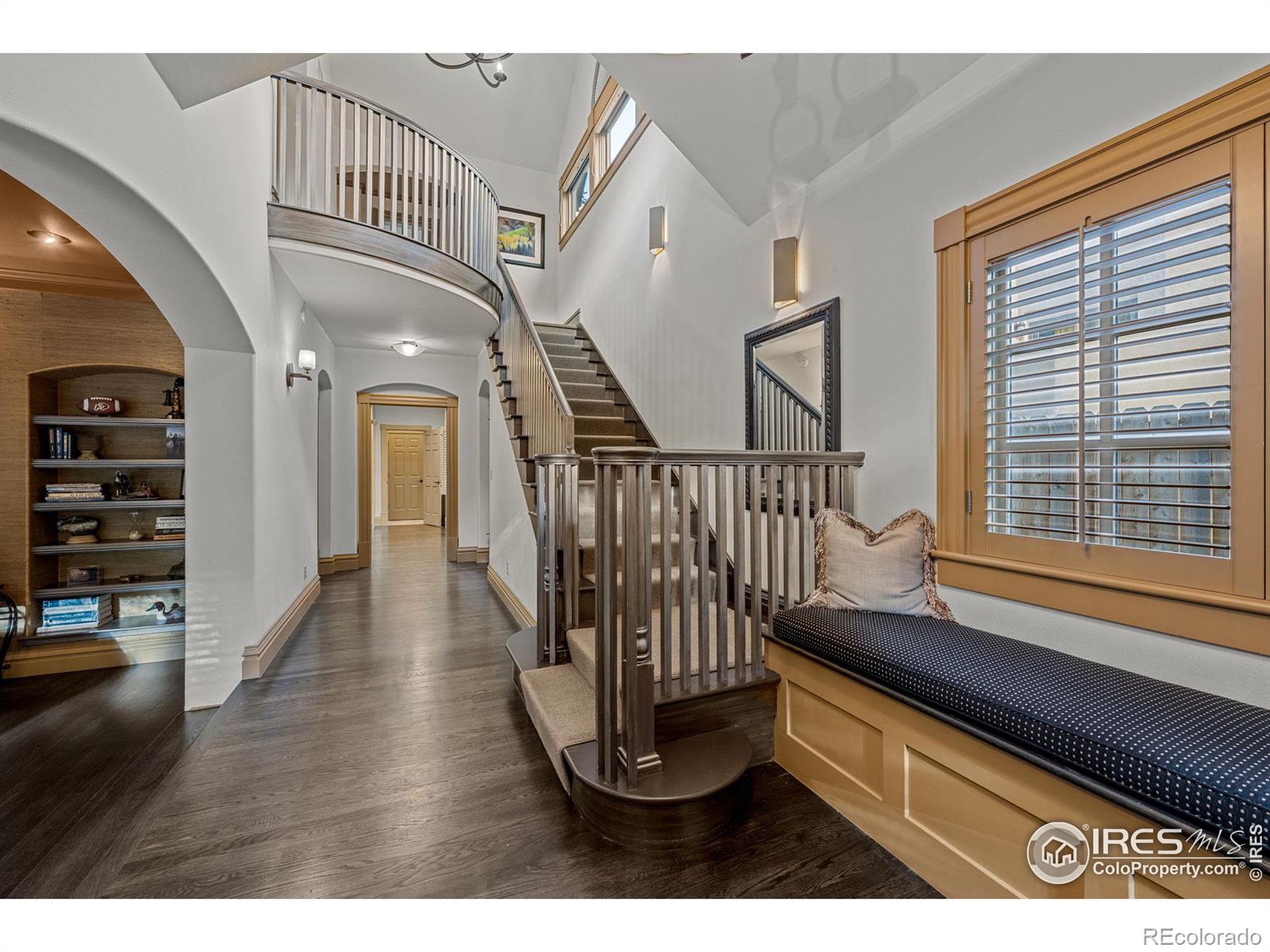 Sweeping staircase greets the front vestibule.