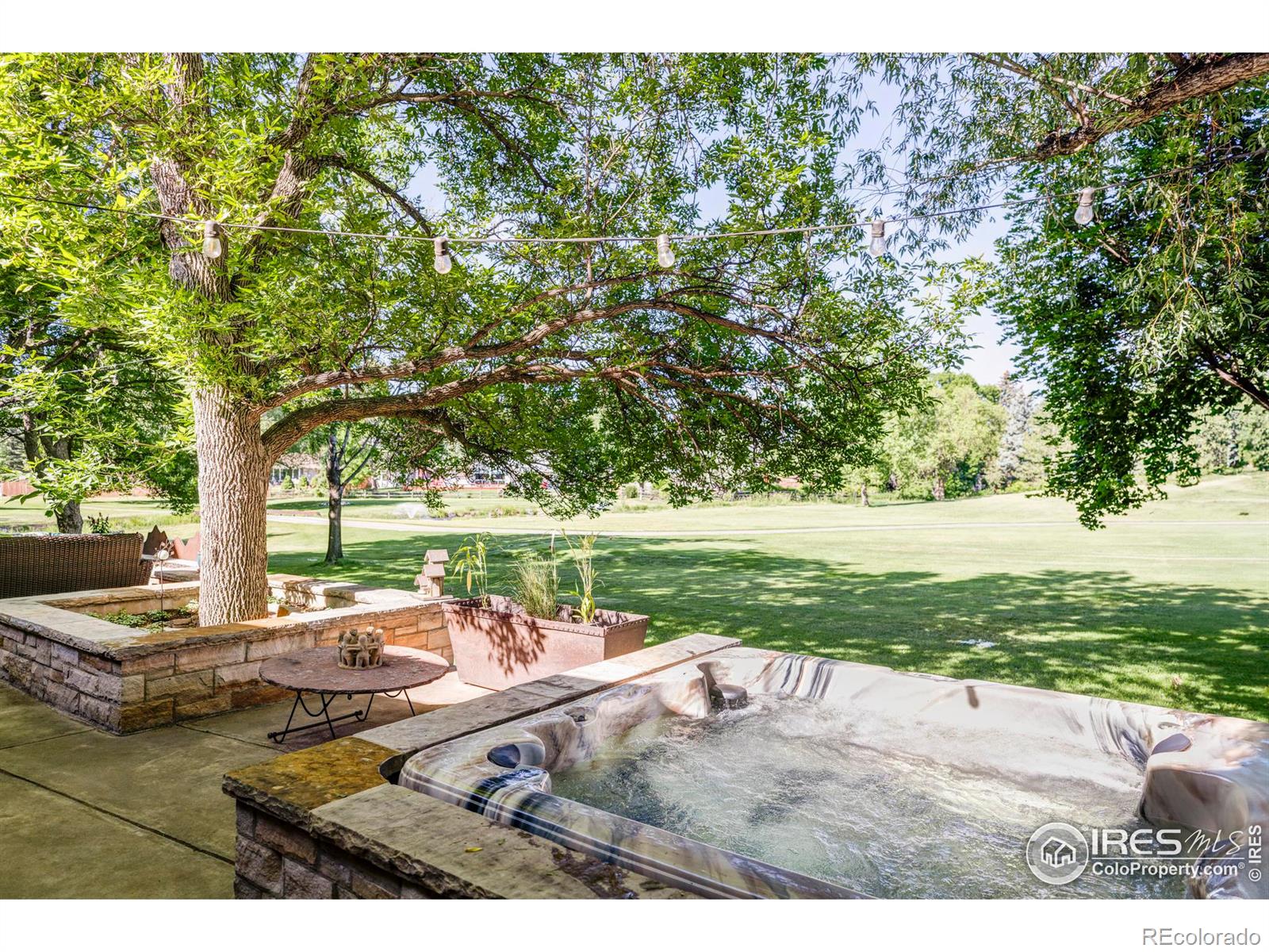 The main-level flex space, complete with a stylish 3/4 bath + walk-in closet, provides seamless access to the patio hot tub area.