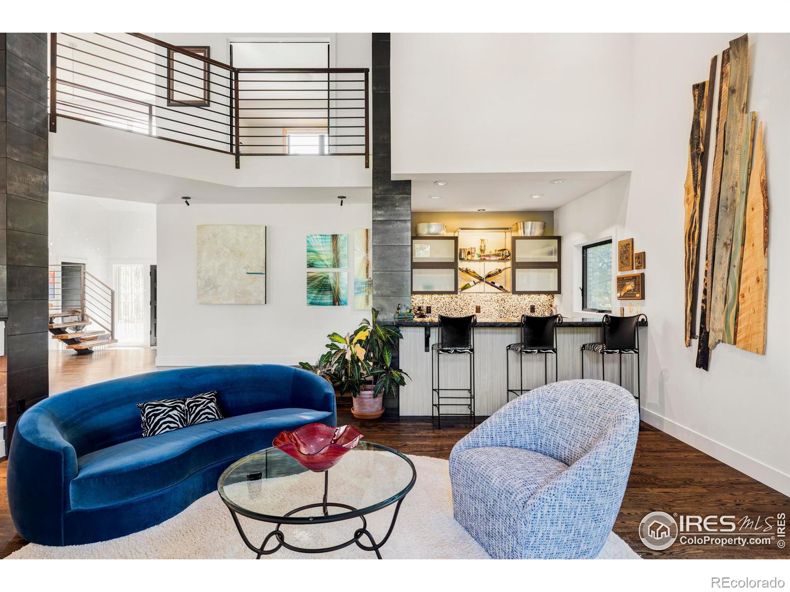 Step down into the sun-filled living room, where a gas fireplace w/custom stone facade adds warmth and charm.