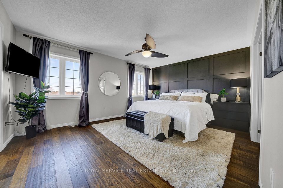 Large Primary Bedroom with Feature Wall & Hardwood