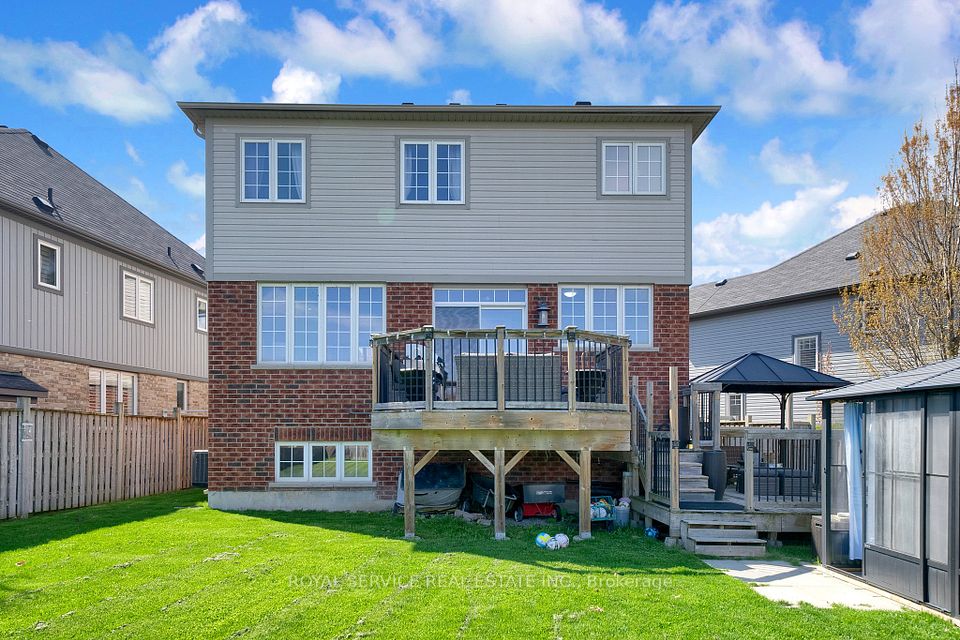 Back of house, lrg basement windows, tiered decks