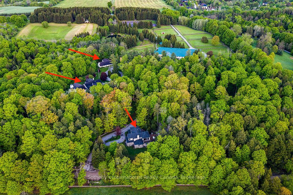 Property view with 3 homes, tennis courts, stable