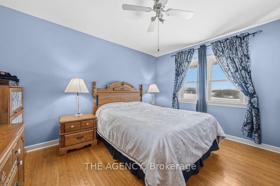 Second bedroom w/ hardwood floors and farm views