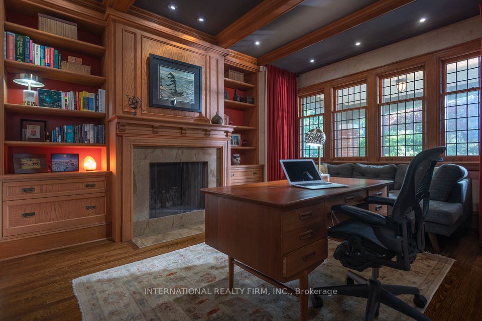 Built in bookcases, fireplace and view of veranda.