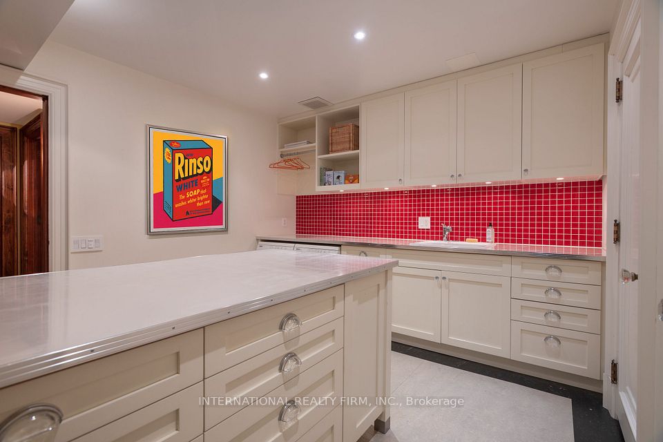 Laundry room has a nice big folding table.