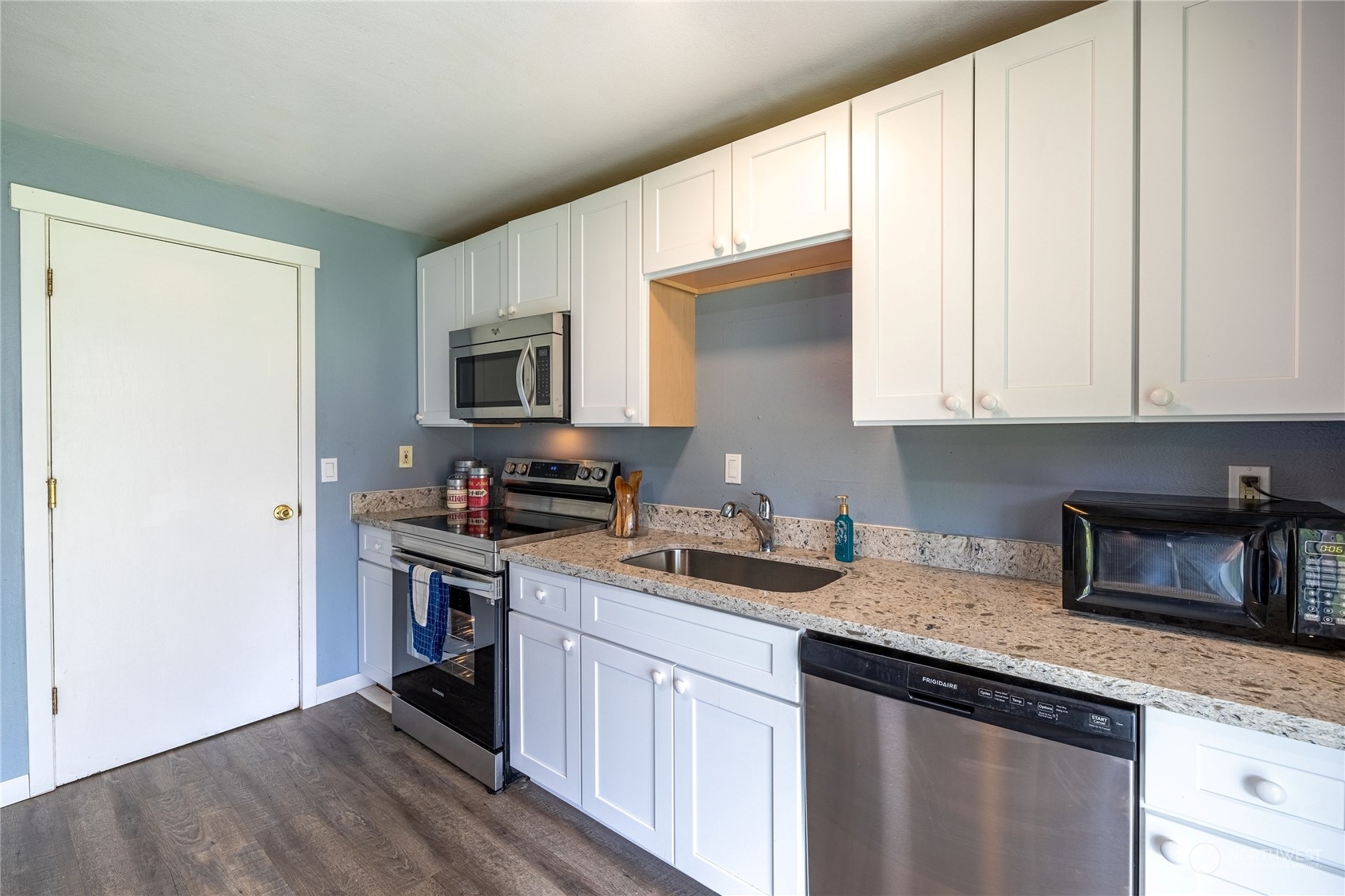 Gleaming granite countertops, painted white cabinets, and stainless steel appliances makes cooking a joy.