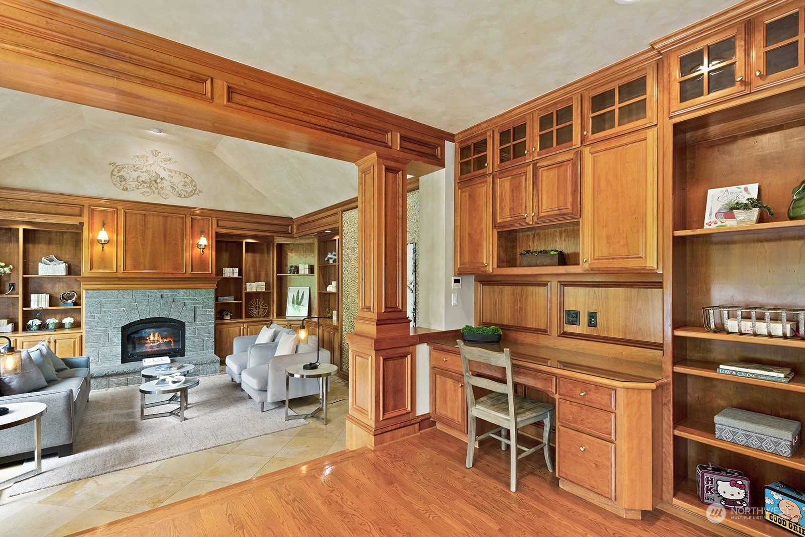 Beautiful cherry wood desk, cabinets and shelving. Gorgeous cherry wood pillars positioned between the kitchen and family room.