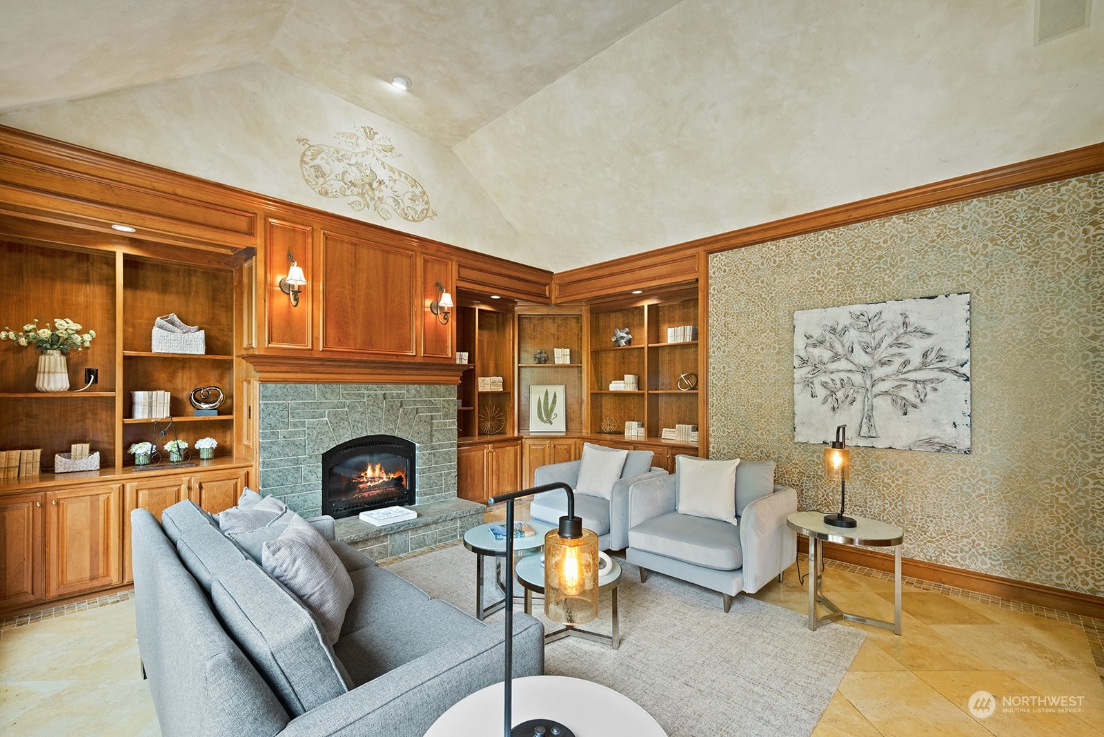 Family room with beautiful built-in cabinets and shelving and a custom vaulted ceiling.