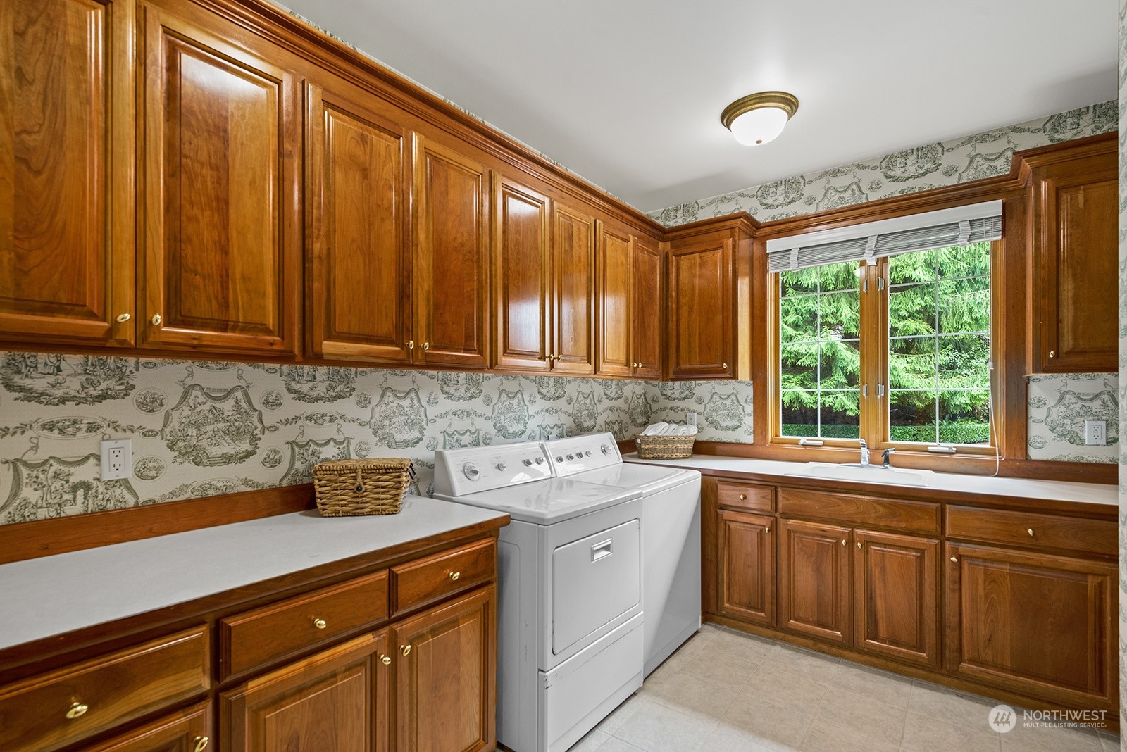 Laundry room on the main level with an abundance of cabinets and countertops.  Washer and dryer stay with the home.