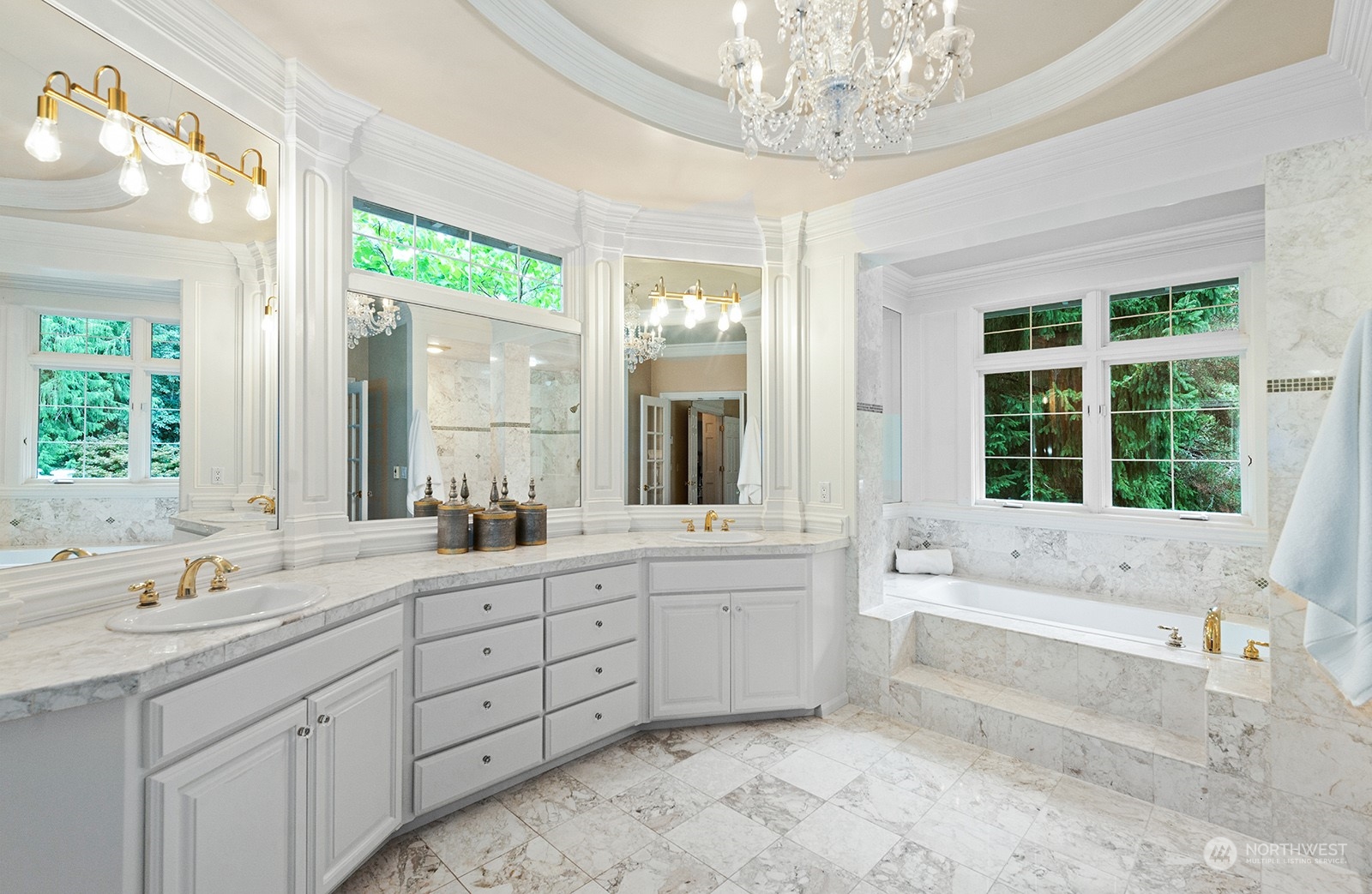 Elegant marble Primary Bathroom with double vanity and soaking tub.