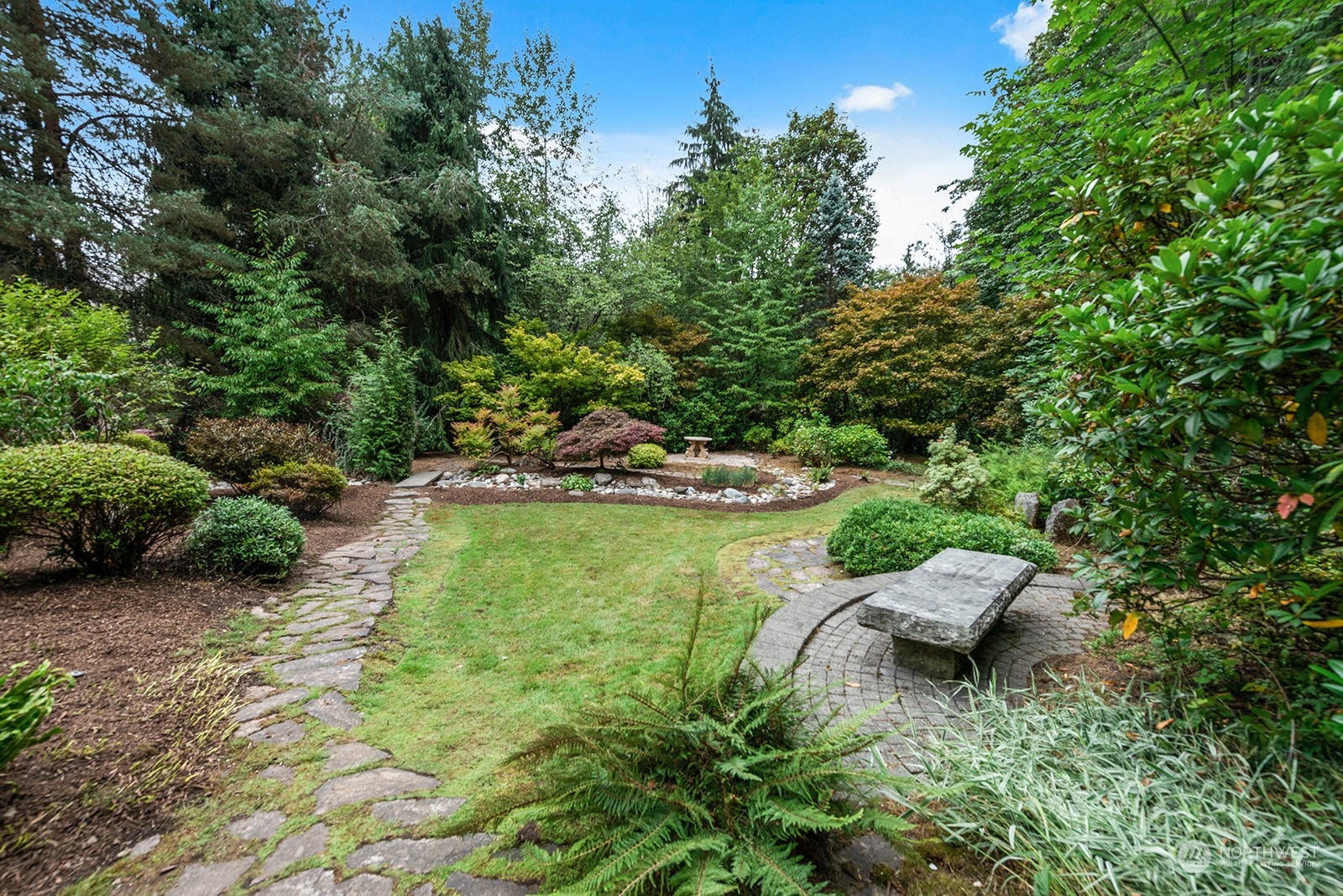 Ground level deck positioned perfectly to relax and enjoy this park like setting.