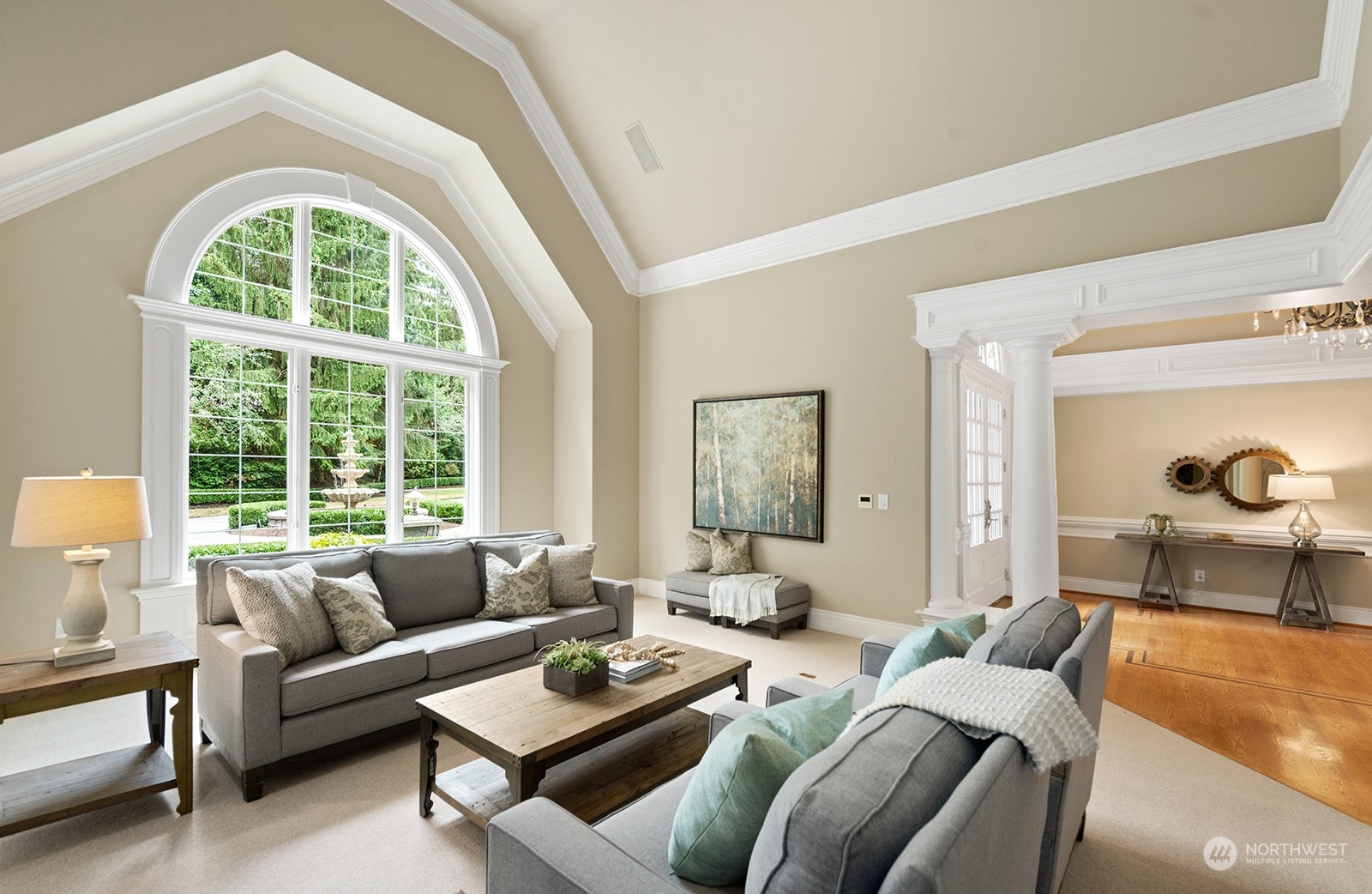 Formal living room with a lovely view of the front circular drive and water feature.