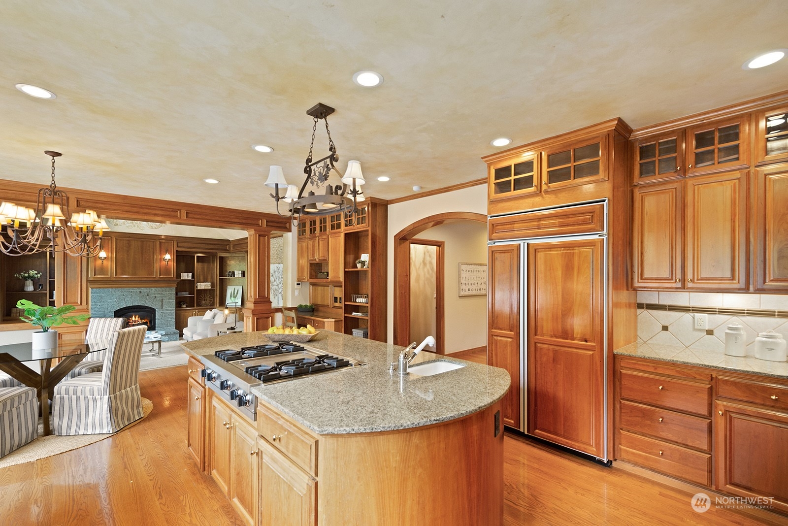 Kitchen with casual dining area and open to the family room. Striking cherry wood cabinets and accent features!