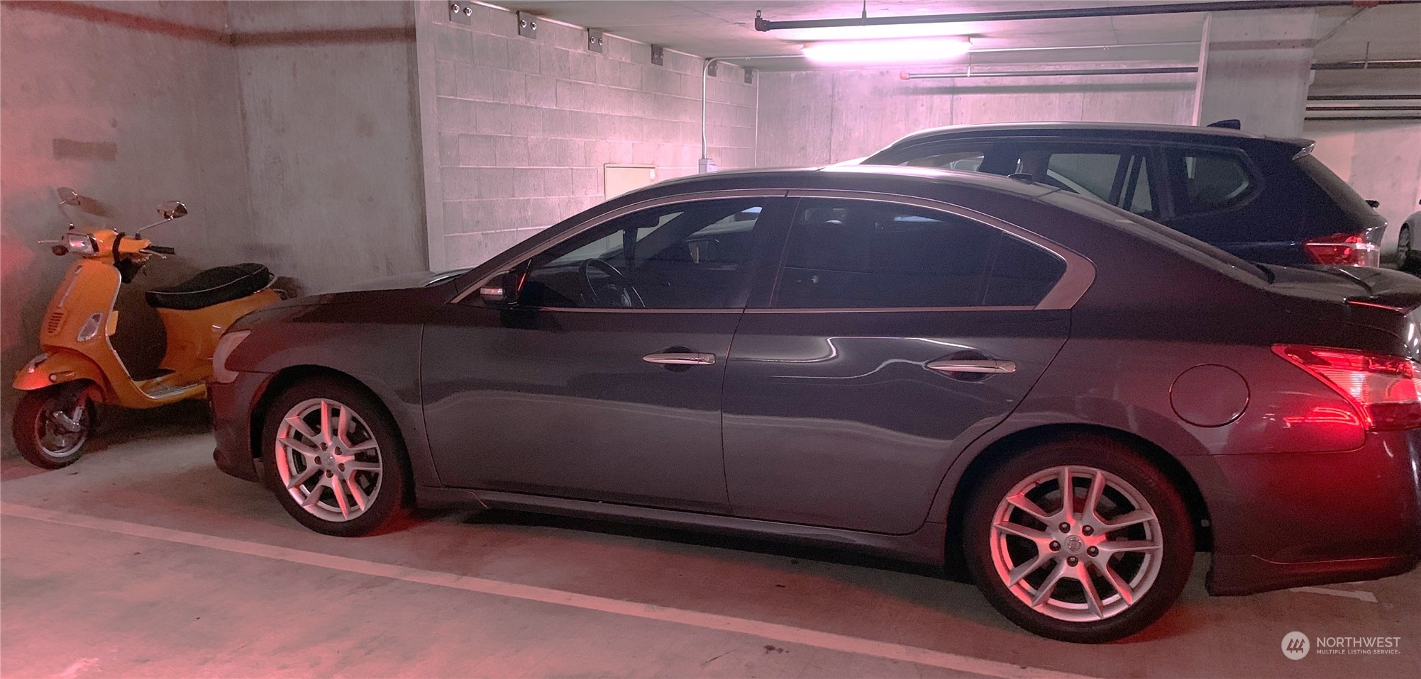 208 has an extra large parking space big enough for car and motorcycle. And there is a community electric car charger available in the garage for use by Ellington residents