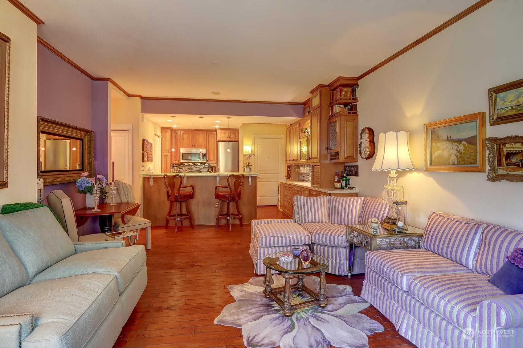 Living room looking back at kitchen showing dining alcove. Table can be pulled out to seat more people