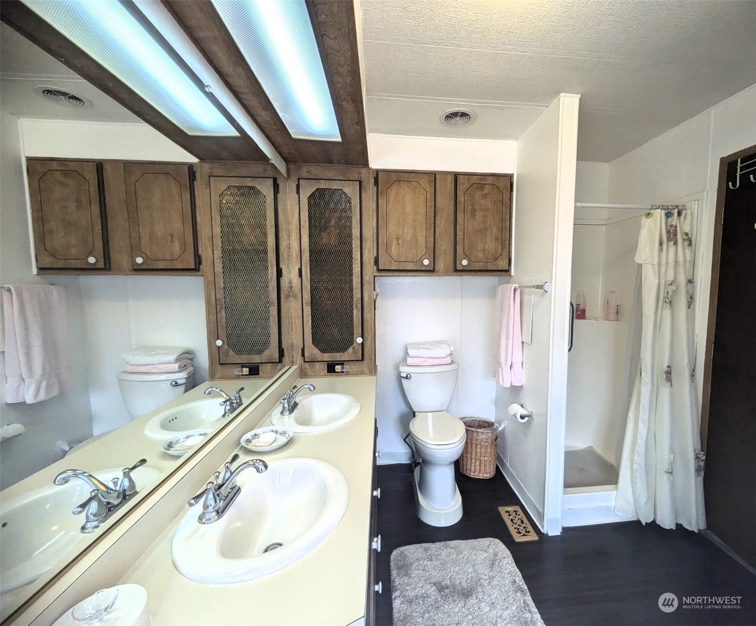 Showing shower and double-sinks. Toilet is professionally raised for convenience