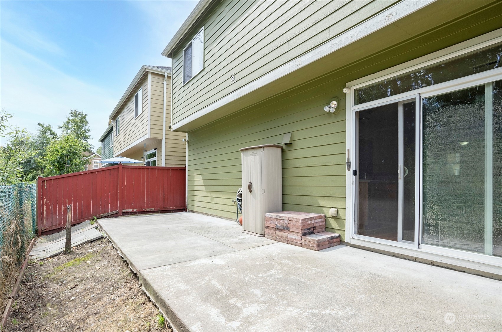 Backyard patio featuring an additional storage cabinet.