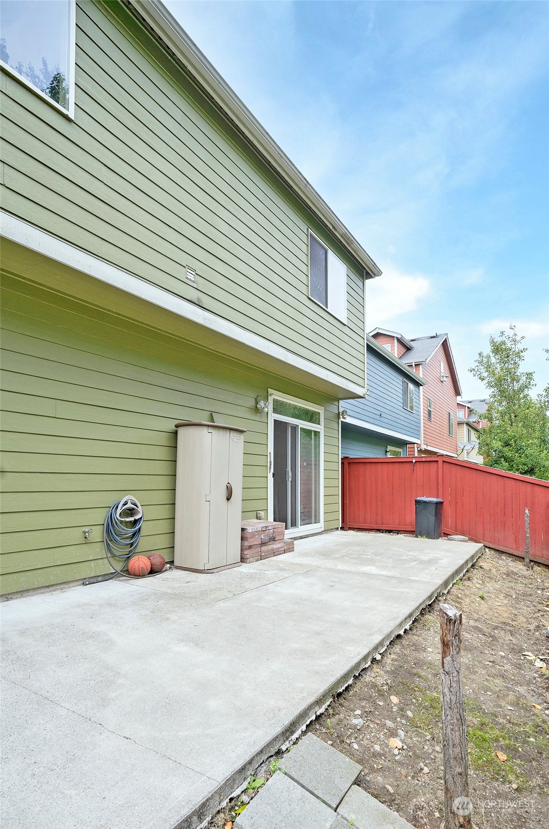 The backyard is fenced on both sides, ensuring privacy.