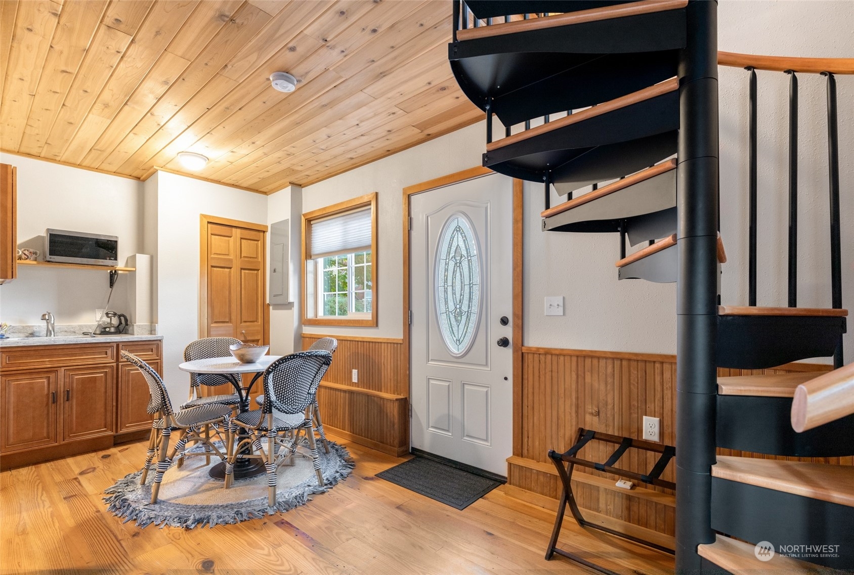 Detached guest house features a Murphy bed, full bathroom, and kitchenette downstairs, along with a beautiful office space upstairs complete with built-in cabinets. A perfect blend of comfort and functionality for guests or as a home office