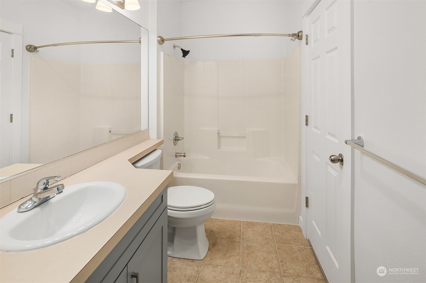 Full bathroom with storage closet attached.