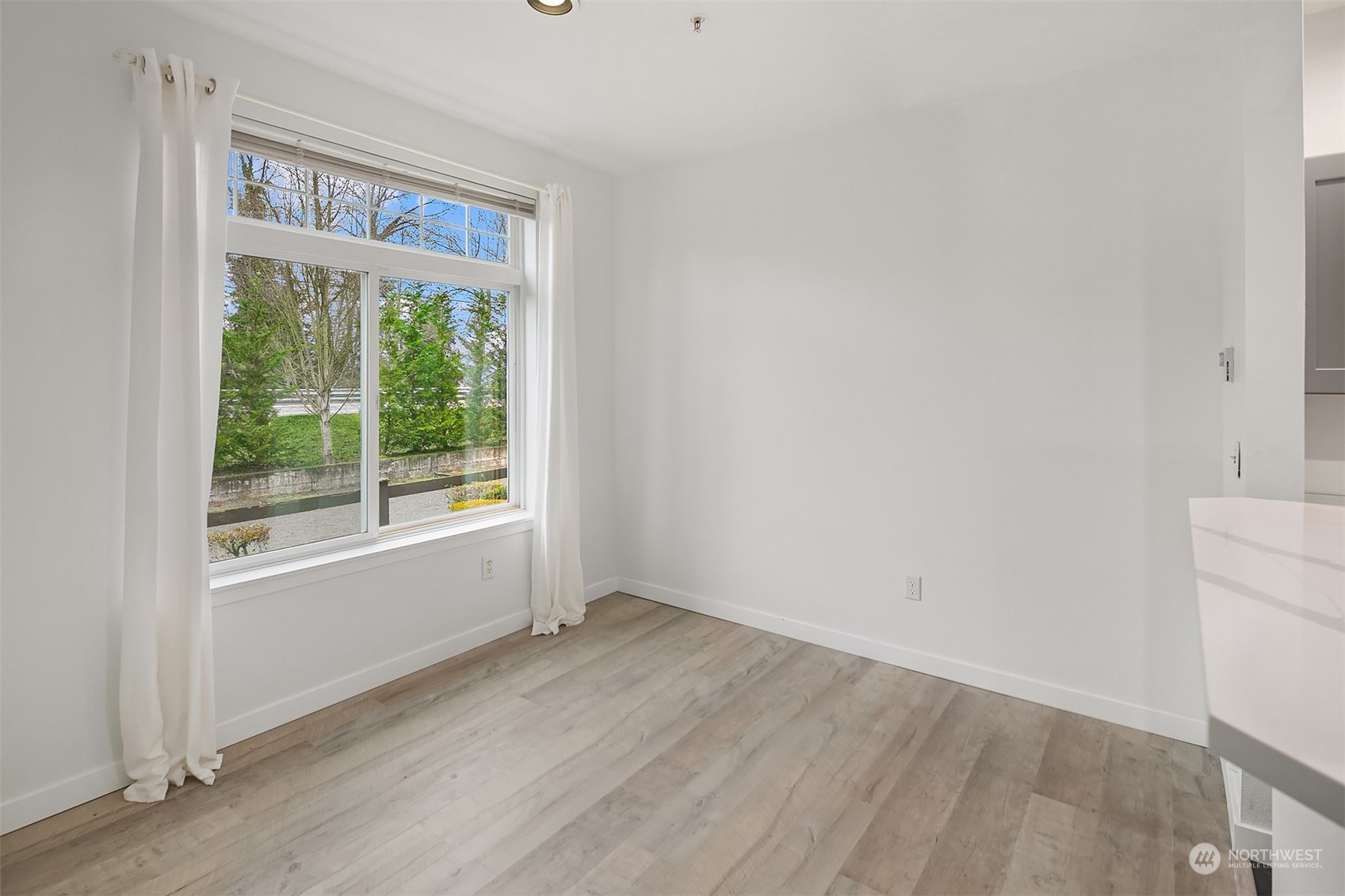 Large window in dining area providing natural light.