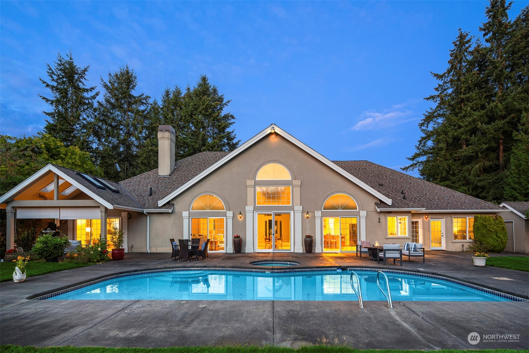 Enjoy outdoor living with a large patio, a sparkling pool, and a soothing hot tub.