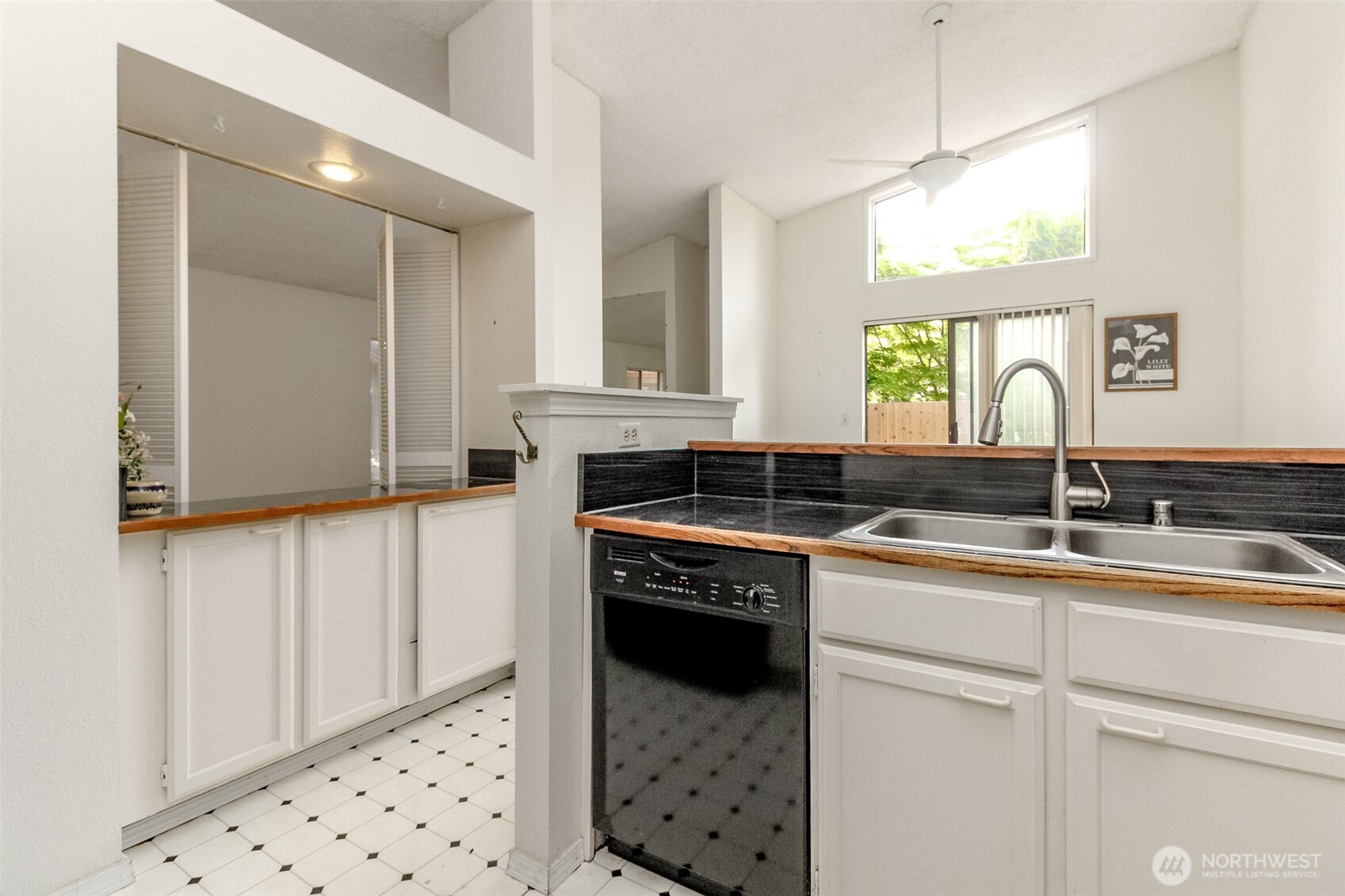 The kitchen has a wet bar which the plumbing is capped I'm the cabinet. The wet bar opens to the living room and there are louvered doors