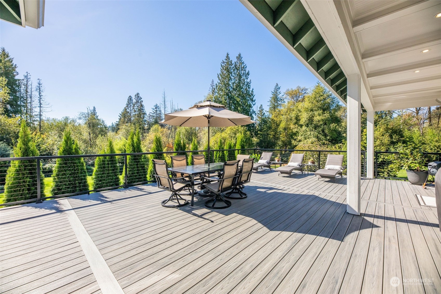 The expansive 1500 square foot deck, overlooking your private forest. Entertain with the outdoor TV & full surround sound.