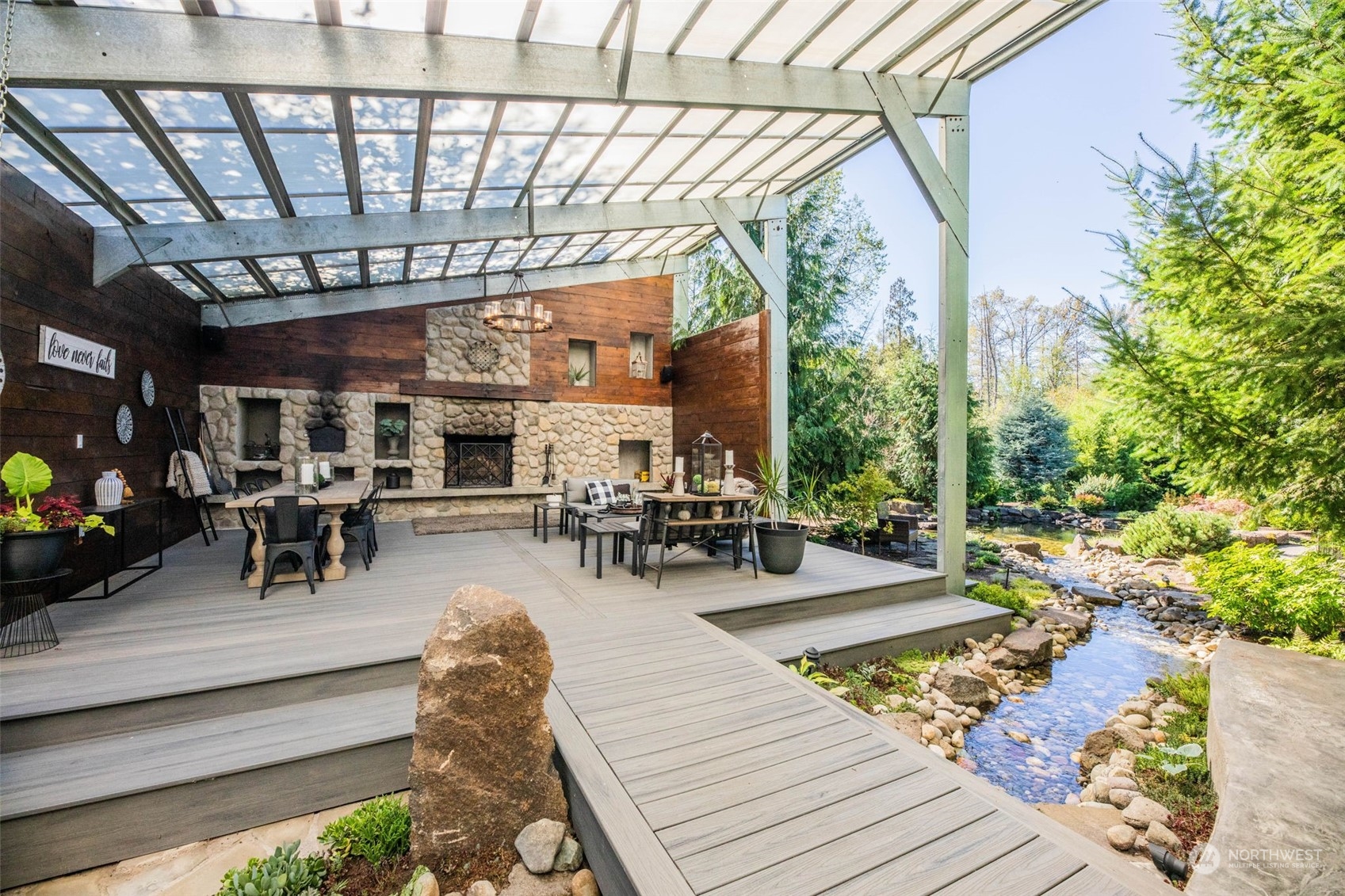 A bridge over the water feature as a transition between the outdoor covered living spaces.