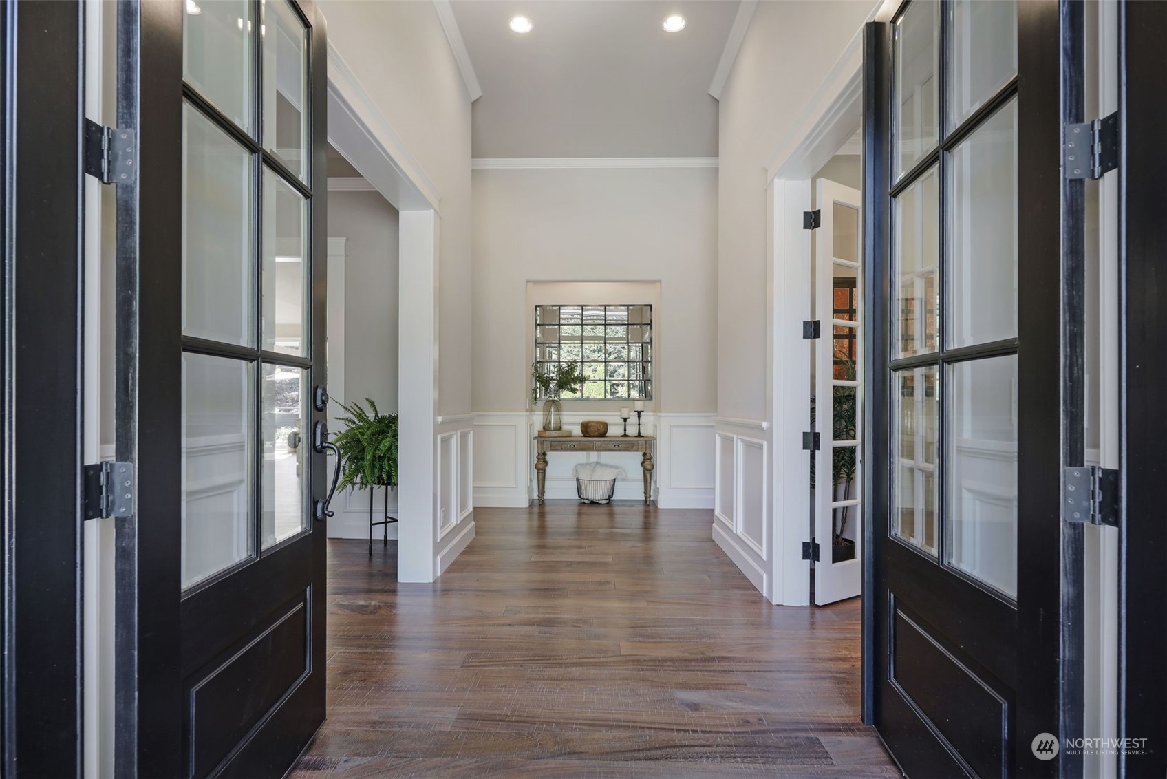 From the moment you walk through the French entry doors, you are immediately greeted by the highest level of craftsmanship and finishes. To the right is a large office with closet for use as a bedroom if desired. To the left is the inviting dining room, conveniently located next to the kitchen