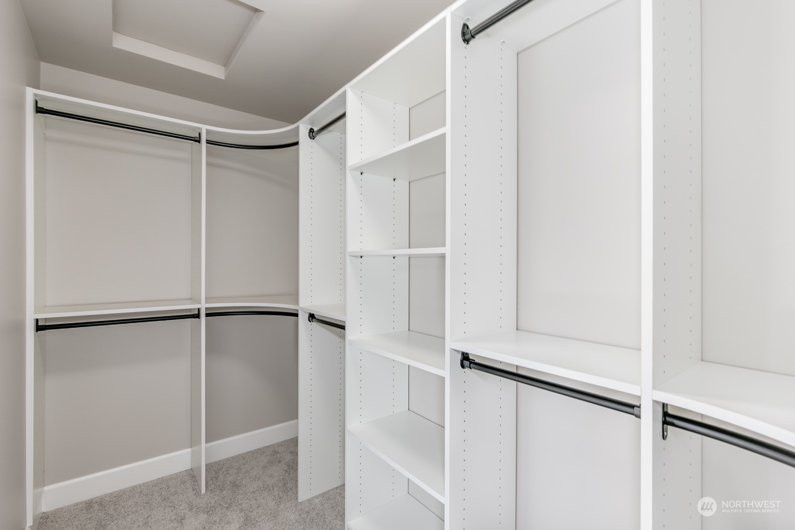 The Primary bedroom offers 2 large walk-in closets, both with solid shelve organizing systems.