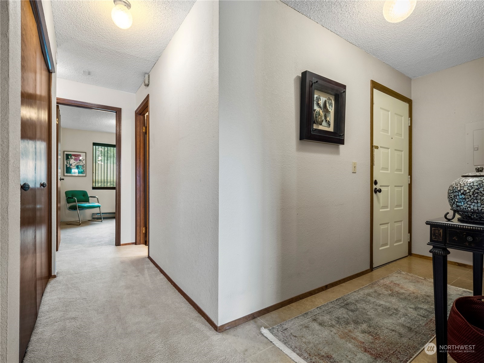 A welcoming entry. The washer and dryer are conviently located behind the folding doors.