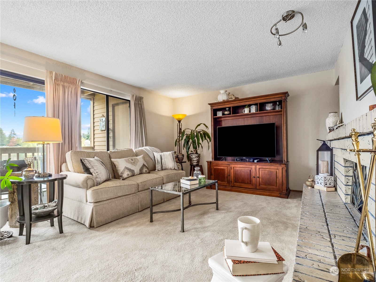 The cozy living room features a charming wood fireplace, adding warmth and character.