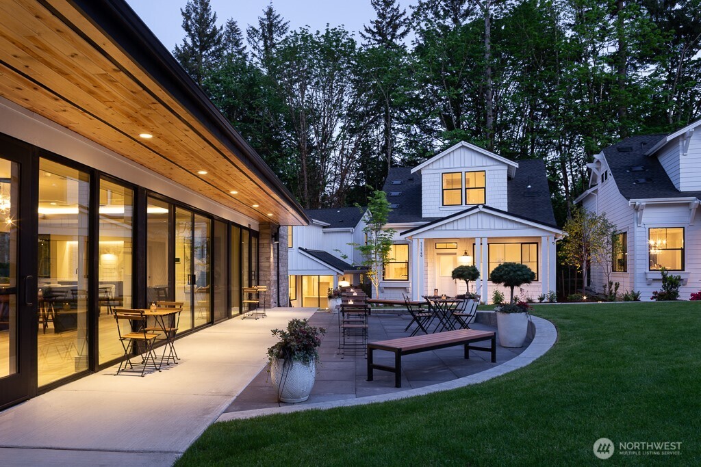 Evening light on Clubhouse patio. A Daisy Farmhouse sits in the background.