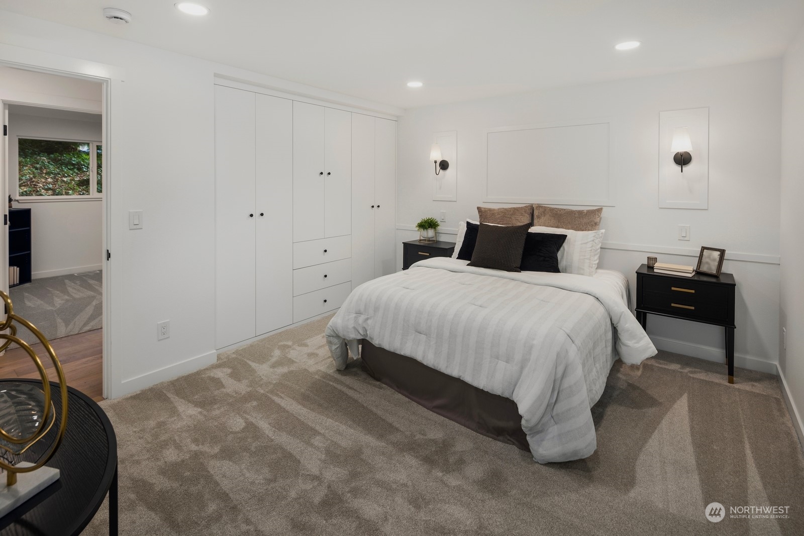 Primary suite with custom designed closet package, sconce lighting, smart wall outlets, and beautiful primary bathroom.